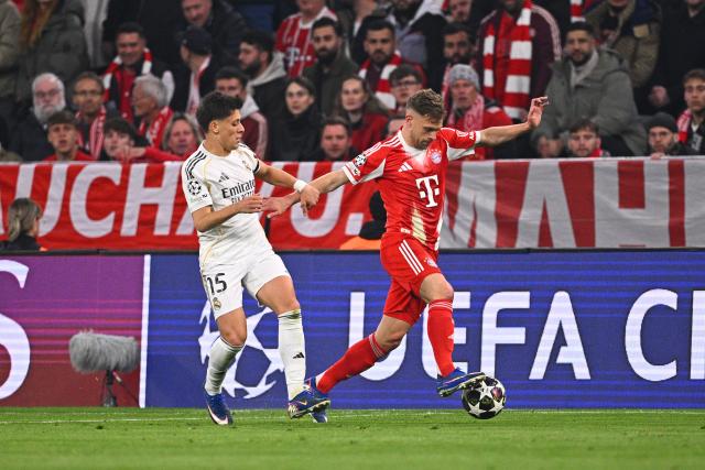 15 April 2026, Bavaria, Munich: Real Madrid's Arda Gueler (L) and Bayern Munich's Joshua Kimmich battle for the ball during the UEFA Champions League Quarterfinal Second Leg soccer match between Bayern Munich and Real Madrid at Allianz Arena. Photo: Tom Weller/dpa