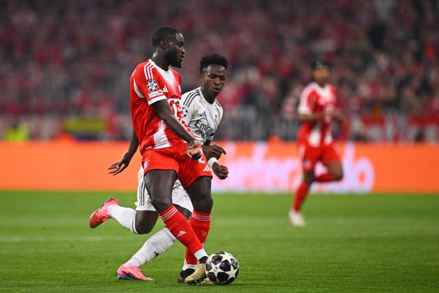 15 April 2026, Bavaria, Munich: Real Madrid's Vinicius Junior and Bayern Munich's Dayot Upamecano (L) battle for the ball during the UEFA Champions League Quarterfinal Second Leg soccer match between Bayern Munich and Real Madrid at Allianz Arena. Photo: Tom Weller/dpa