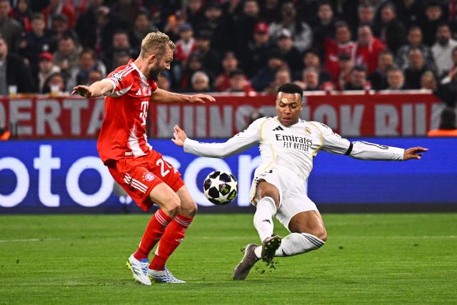 15 April 2026, Bavaria, Munich: Real Madrid's Kylian Mbappe (R) and Bayern Munich's Konrad Laimer battle for the ball during the UEFA Champions League Quarterfinal Second Leg soccer match between Bayern Munich and Real Madrid at Allianz Arena. Photo: Tom Weller/dpa