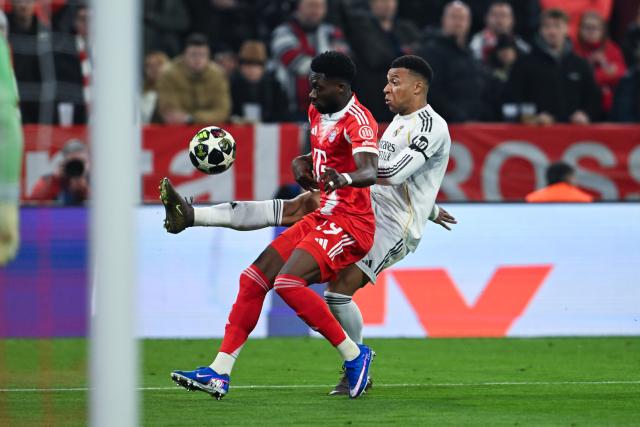 15 April 2026, Bavaria, Munich: Real Madrid's Kylian Mbappe (R) and Bayern Munich's Alphonso Davies battle for the ball during the UEFA Champions League Quarterfinal Second Leg soccer match between Bayern Munich and Real Madrid at Allianz Arena. Photo: Sven Hoppe/dpa