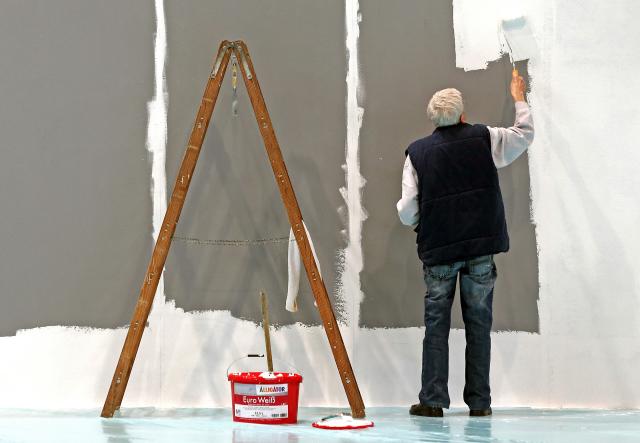 FILED - 17 February 2014, Saarland, Leipzig: An older man with gray hair is painting a wall at the Leipzig Trade Fair in Leipzig. The number of people aged over 65 still in work in Germany has risen by about 46% over the past five years to around 1.9 million, official figures showed on Thursday. Photo: Jan Woitas/dpa