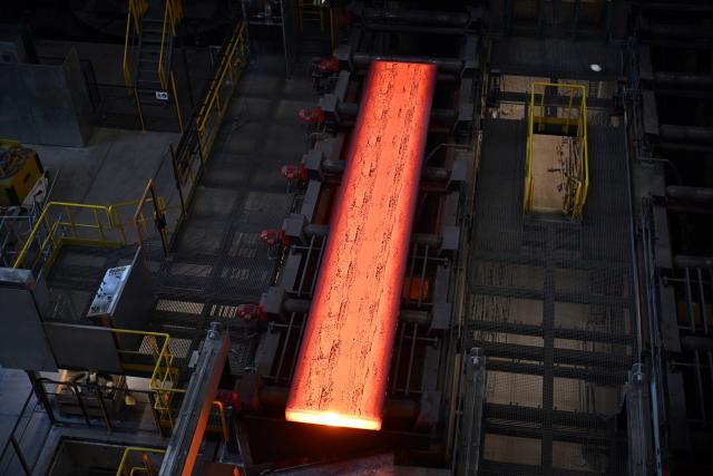 FILED - 04 July 2025, North Rhine-Westphalia, Duisburg: Glowing slabs come out of the continuous casting plant at Thyssenkrupp Steel on transport rollers. The European Commissionon Thursday approved plans by the German government to support energy-intense industries with ·3.8 billion ($4.5 billion) in the coming years. Photo: Federico Gambarini/dpa