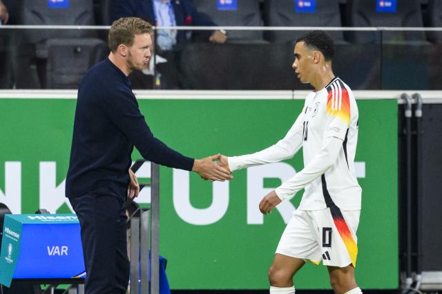 FILED - 23 June 2024, Hesse, Frankfurt/M.: German national team coach Julian Nagelsmann (L) shakes hands with Germany's Jamal Musiala after he was substituted during the 2024 UEFA Euro Championship group A soccer match between Switzerland and Germany at Frankfurt Arena. Photo: Tom Weller/dpa