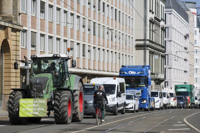 17 April 2026, Saxony, Leipzig: A tractor, trucks, vans and cars drive through Leipzig city center as part of a protest against high fuel costs. Companies from the Ore Mountains also joined the convoy against high fuel prices. Photo: Jan Woitas/dpa