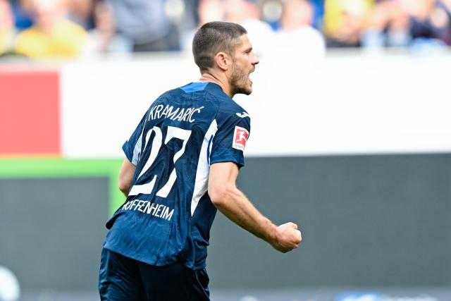 18 April 2026, Baden-Wuerttemberg, Sinsheim: Hoffenheim's Andrej Kramaric celebrates scoring his side's first goal during the German Bundesliga soccer match between TSG 1899 Hoffenheim and Borussia Dortmund at PreZero Arena. Photo: Uwe Anspach/dpa - WICHTIGER HINWEIS: Gemäß den Vorgaben der DFL Deutsche Fußball Liga bzw. des DFB Deutscher Fußball-Bund ist es untersagt, in dem Stadion und/oder vom Spiel angefertigte Fotoaufnahmen in Form von Sequenzbildern und/oder videoähnlichen Fotostrecken zu verwerten bzw. verwerten zu lassen.