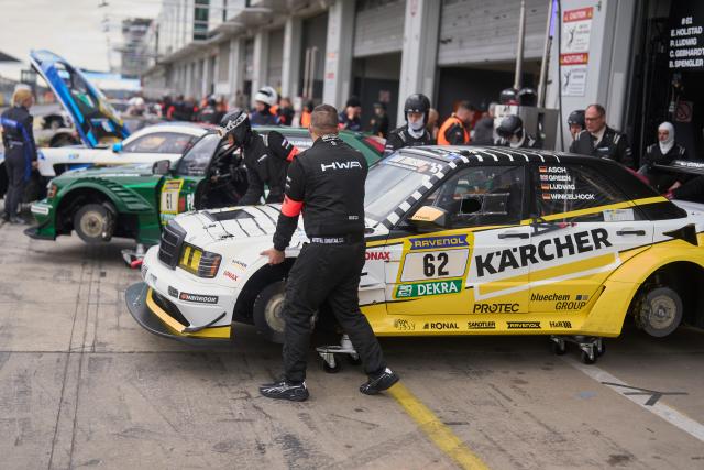 18 April 2026, Rhineland-Palatinate, Nuremberg: Drivers and technicians use the time of a race interruption for maintenance work. One driver was killed in the serious mass accident in the qualifying race for the Nürburgring 24 Hours. Photo: Thomas Frey/dpa