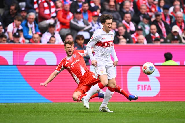 19 April 2026, Bavaria, Munich: Bayern Munich's Joshua Kimmich (L) and Stuttgart's Angelo Stiller battle for the ball during the German Bundesliga championship trophy ahead of the German Bundesliga soccer match between Bayern Munich and VfB Stuttgart at Allianz Arena. Photo: Tom Weller/dpa - IMPORTANT NOTICE: DFL and DFB regulations prohibit any use of photographs as image sequences and/or quasi-video.