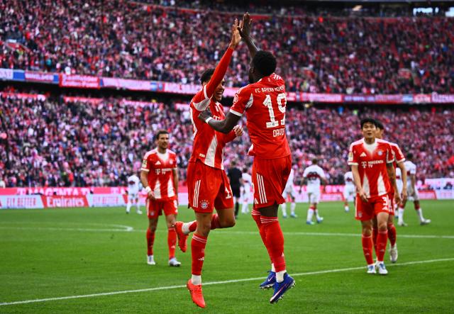 19 April 2026, Bavaria, Munich: Bayern Munich's Alphonso Davies (R) celebrates his side's third goal of the game during the German Bundesliga soccer match between Bayern Munich and VfB Stuttgart at the Allianz Arena. Photo: Tom Weller/dpa - IMPORTANT NOTICE: DFL and DFB regulations prohibit any use of photographs as image sequences and/or quasi-video.