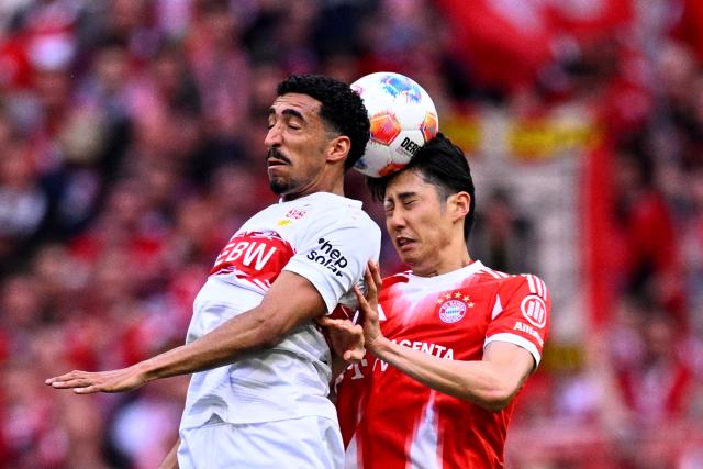 19 April 2026, Bavaria, Munich: Stuttgart's Tiago Tomas (L) and Bayern Munich's Hiroki Ito battle for a header during the German Bundesliga soccer match between Bayern Munich and VfB Stuttgart at the Allianz Arena. Photo: Tom Weller/dpa - IMPORTANT NOTICE: DFL and DFB regulations prohibit any use of photographs as image sequences and/or quasi-video.