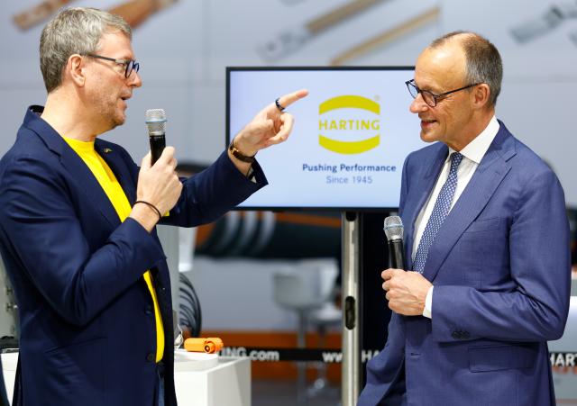 20 April 2026, Lower Saxony, Hanover: German Chancellor Friedrich Merz stands with Philip Harting, CEO of the Harting Technology Group, at the Harting stand during  the opening tour of the Hannover Messe. Brazil is the partner country at this year's Hannover Messe. Photo: Moritz Frankenberg/dpa