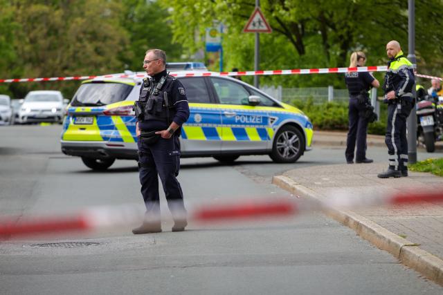 20 April 2026, North Rhine-Westphalia, Wuppertal: Forensic officers from the KTU collect evidence at the crime scene as a possible murder weapon, a knife, lies on the street in Wuppertal. A man attacked and injured his partner in Wuppertal. Photo: Christoph Reichwein/dpa