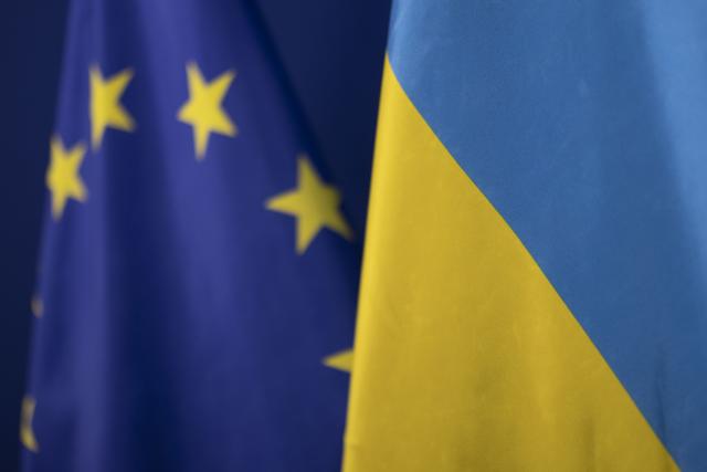 FILED - 28 February 2023, North Rhine-Westphalia, Duesseldorf: The flag of Ukraine stands in front of the flag of the European Union. Photo: Christoph Reichwein/dpa