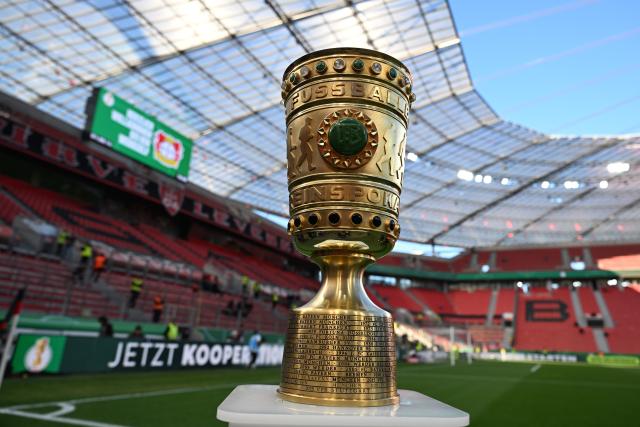 22 April 2026, North Rhine-Westphalia, Leverkusen: The German DFB Cup trophy is displayed on a pedestal at the edge of the field prior to the start of the German DFB Cup semifinal soccer match between Bayer Leverkusen and Bayern Munich at BayArena. Photo: Federico Gambarini/dpa - IMPORTANT NOTICE: DFL and DFB regulations prohibit any use of photographs as image sequences and/or quasi-video.