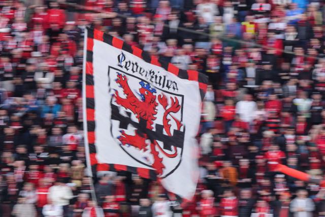 22 April 2026, North Rhine-Westphalia, Leverkusen: Bayer Leverkusen fans wave flag ahead of the the German DFB Cup semifinal soccer match between Bayer Leverkusen and Bayern Munich at BayArena. Photo: Rolf Vennenbernd/dpa - IMPORTANT NOTICE: DFL and DFB regulations prohibit any use of photographs as image sequences and/or quasi-video.