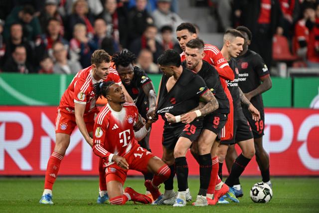 22 April 2026, North Rhine-Westphalia, Leverkusen: Bayern Munich's Michael Olise (2nd L) clashes with Bayer Leverkusen's Exequiel Palacios during the German DFB Cup semifinal soccer match between Bayer Leverkusen and Bayern Munich at BayArena. Photo: Federico Gambarini/dpa - IMPORTANT NOTICE: DFL and DFB regulations prohibit any use of photographs as image sequences and/or quasi-video.