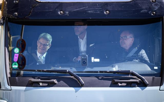 23 April 2026, Berlin: Patrick Schnieder (L), German Minister of Transport, takes a test drive in an electrically powered heavy goods vehicle together with Wolfgang Brand, CFO of Milence, the operator of the largest public fast-charging network for heavy goods vehicles in Europe, and driver Michael Noll (r) from MAN at a press event on the expansion of the public charging infrastructure network for electric trucks. The convoy of five electric heavy-duty trucks from the manufacturers Daimler Truck, MAN, Renault Trucks and Volvo Trucks had previously driven over 1,000 kilometers from Paris to Berlin. Photo: Bernd von Jutrczenka/dpa