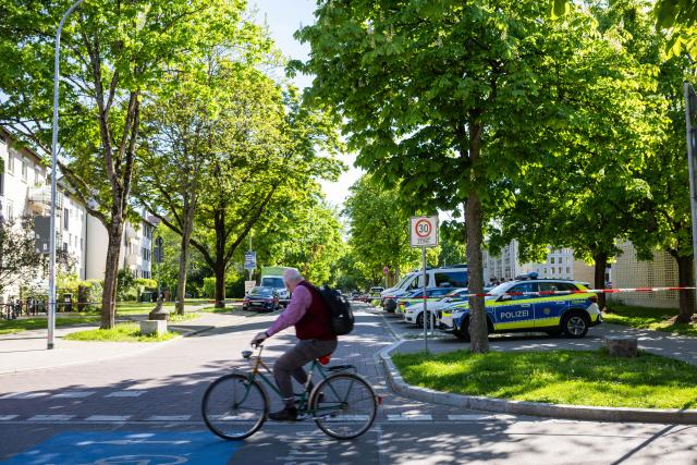 23 April 2026, Baden-Wuerttemberg, Freiburg: A cyclist rides past a police cordon after suspected hazardous materials were found in the basement of a house, prompting authorities to seal off a wide area before the chemicals were later safely detonated. Photo: Philipp von Ditfurth/dpa