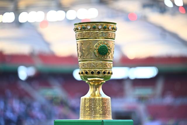 23 April 2026, Baden-Wuerttemberg, Stuttgart: The German DFB Cup trophy is displayed on a pedestal at the edge of the field ahead of the German DFB Cup semifinal soccer match between VfB Stuttgart and SC Freiburg at MHPArena. Photo: Tom Weller/dpa - IMPORTANT NOTICE: DFL and DFB regulations prohibit any use of photographs as image sequences and/or quasi-video.