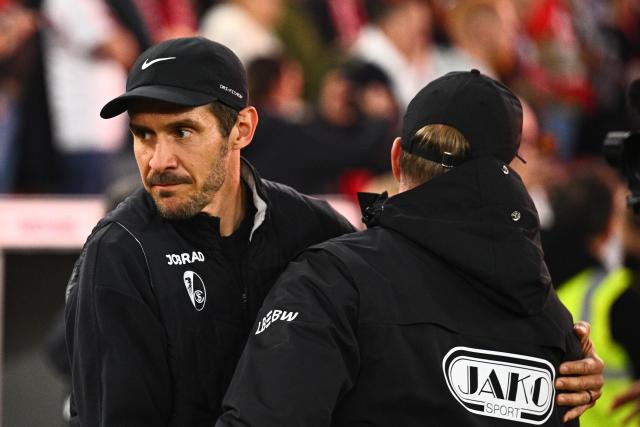 23 April 2026, Baden-Wuerttemberg, Stuttgart: Freiburg coach Julian Schuster (L) and Stuttgart coach Sebastian Hoeness embrace ahead of the German DFB Cup semifinal soccer match between VfB Stuttgart and SC Freiburg at MHPArena. Photo: Tom Weller/dpa - IMPORTANT NOTICE: DFL and DFB regulations prohibit any use of photographs as image sequences and/or quasi-video.
