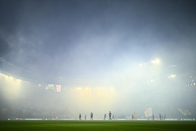 23 April 2026, Baden-Wuerttemberg, Stuttgart: The stadium is filled with smoke from pyrotechnics ahead of the German DFB Cup semifinal soccer match between VfB Stuttgart and SC Freiburg at MHPArena. Photo: Tom Weller/dpa - IMPORTANT NOTICE: DFL and DFB regulations prohibit any use of photographs as image sequences and/or quasi-video.