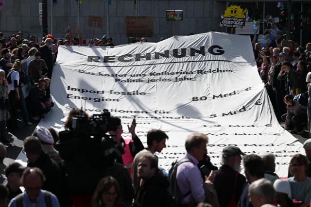 24 April 2026, Berlin: Protesters stand in front of the Christian Democratic Union (CDU) headquarters, unfurling a banner listing what they describe as the federal government's misguided energy policy decisions as part of the 'Fridays for Future' campaign. Photo: Soeren Stache/dpa