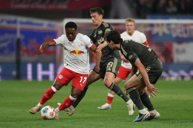 24 April 2026, Saxony, Leipzig: (L-R) Leipzig's Ridle Baku, Union Berlin's Janik Haberer, and Union Berlin's Diogo Leite battle for the ball during the German Bundesliga soccer match between RB Leipzig and 1. FC Union Berlin at Red Bull Arena. Photo: Jan Woitas/dpa - IMPORTANT NOTICE: DFL and DFB regulations prohibit any use of photographs as image sequences and/or quasi-video.