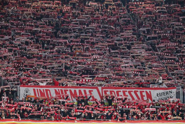 24 April 2026, Saxony, Leipzig: Berlin fans cheer on their team during the German Bundesliga soccer match between RB Leipzig and 1. FC Union Berlin at Red Bull Arena. Photo: Jan Woitas/dpa - IMPORTANT NOTICE: DFL and DFB regulations prohibit any use of photographs as image sequences and/or quasi-video.