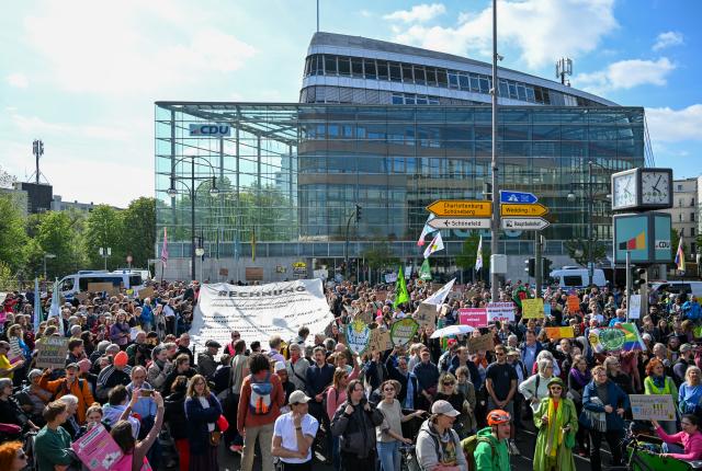 24 April 2026, Berlin: Demonstrators stand in front of the Christian Democratic Union (CDU) party headquarters during the "Fridays for Future" demonstration. Photo: Soeren Stache/dpa