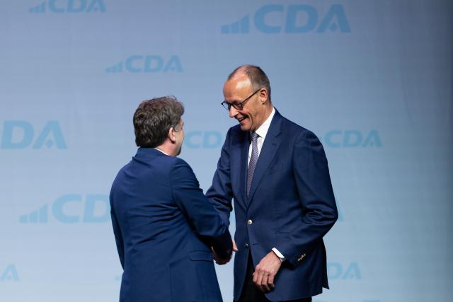 25 April 2026, Hesse, Marburg: German Chancellor Friedrich Merz and Dennis Radtke (R), CDA Federal Chairman, on stage at the 41st Federal Conference of the Christian Democratic Workers' Association (CDA). Photo: Florian Wiegand/dpa