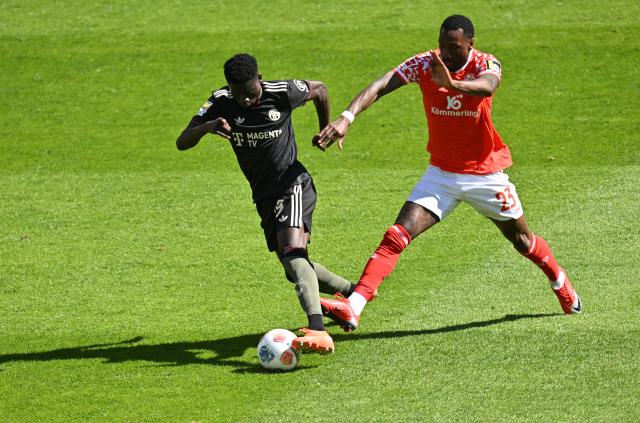 25 April 2026, Rhineland-Palatinate, Mainz: Mainz's Sheraldo Becker and Bayern Munich's Bara Sapotko Ndiaye battle for the ball during the German Bundesliga soccer match between FSV Mainz 05 and Bayern Munich at Mewa Arena. Photo: Torsten Silz/dpa - WICHTIGER HINWEIS: Gemäß den Vorgaben der DFL Deutsche Fußball Liga bzw. des DFB Deutscher Fußball-Bund ist es untersagt, in dem Stadion und/oder vom Spiel angefertigte Fotoaufnahmen in Form von Sequenzbildern und/oder videoähnlichen Fotostrecken zu verwerten bzw. verwerten zu lassen.