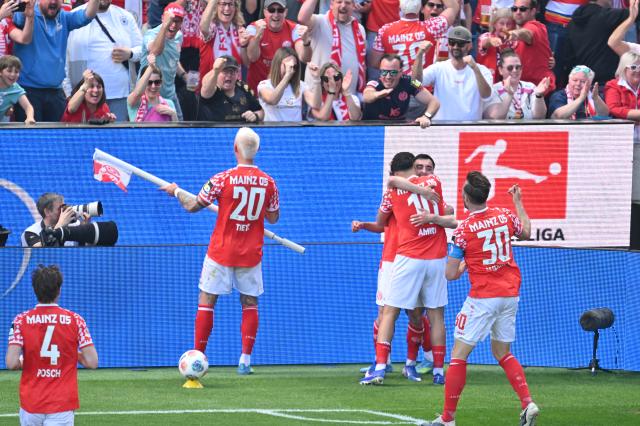 25 April 2026, Rhineland-Palatinate, Mainz: Mainz's Paul Nebel and Nadiem Amiri celebrate with their teammates after scoring their side's second goal of the game during the German Bundesliga soccer match between FSV Mainz 05 and Bayern Munich at Mewa Arena. Photo: Torsten Silz/dpa - WICHTIGER HINWEIS: Gemäß den Vorgaben der DFL Deutsche Fußball Liga bzw. des DFB Deutscher Fußball-Bund ist es untersagt, in dem Stadion und/oder vom Spiel angefertigte Fotoaufnahmen in Form von Sequenzbildern und/oder videoähnlichen Fotostrecken zu verwerten bzw. verwerten zu lassen.