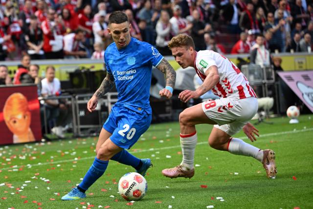 25 April 2026, North Rhine-Westphalia, Cologne: Cologne's Sebastian Sebulonsen and Leverkusen's Alex Grimaldo battle for the ball during the German Bundesliga soccer match between 1. FC Cologne and Bayer Leverkusen at RheinEnergieSTADION. Photo: Federico Gambarini/dpa - WICHTIGER HINWEIS: Gemäß den Vorgaben der DFL Deutsche Fußball Liga bzw. des DFB Deutscher Fußball-Bund ist es untersagt, in dem Stadion und/oder vom Spiel angefertigte Fotoaufnahmen in Form von Sequenzbildern und/oder videoähnlichen Fotostrecken zu verwerten bzw. verwerten zu lassen.