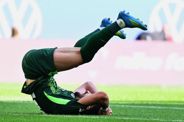 25 April 2026, Lower Saxony, Wolfsburg: Wolfsburg's Mohamed Amoura lies on the ground during the German Bundesliga soccer match between VfL Wolfsburg and Borussia Moenchengladbach at the Volkswagen Arena. Photo: Swen Pförtner/dpa - IMPORTANT NOTE: In accordance with the regulations of the DFL German Football League and the DFB German Football Association, it is prohibited to utilize or have utilized photographs taken in the stadium and/or of the match in the form of sequential images and/or video-like photo series.