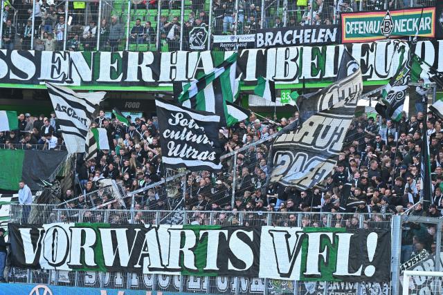 25 April 2026, Lower Saxony, Wolfsburg: Borussia Moenchengladbach fans display numerous flags and banners in the stands during the German Bundesliga soccer match between VfL Wolfsburg and Borussia Moenchengladbach at the Volkswagen Arena. Photo: Swen Pförtner/dpa - IMPORTANT NOTE: In accordance with the regulations of the DFL German Football League and the DFB German Football Association, it is prohibited to utilize or have utilized photographs taken in the stadium and/or of the match in the form of sequential images and/or video-like photo series.