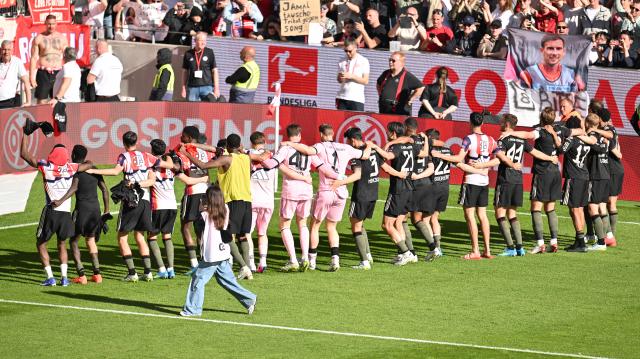 25 April 2026, Rhineland-Palatinate, Mainz: The Bayern Munich team celebrates the victory with their fans after the German Bundesliga soccer match between FSV Mainz 05 and Bayern Munich at Mewa Arena. Photo: Torsten Silz/dpa - WICHTIGER HINWEIS: Gemäß den Vorgaben der DFL Deutsche Fußball Liga bzw. des DFB Deutscher Fußball-Bund ist es untersagt, in dem Stadion und/oder vom Spiel angefertigte Fotoaufnahmen in Form von Sequenzbildern und/oder videoähnlichen Fotostrecken zu verwerten bzw. verwerten zu lassen.