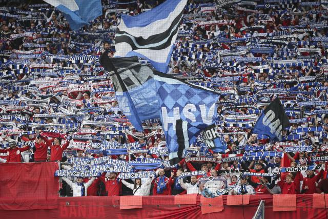 25 April 2026, Hamburg: HSV fans in the North Stand celebrate their team with a choreographed display and pyrotechnics during the German Bundesliga soccer match between Hamburger SV and TSG 1899 Hoffenheim at Volksparkstadion. Photo: Christian Charisius/dpa - IMPORTANT NOTICE: DFL and DFB regulations prohibit any use of photographs as image sequences and/or quasi-video.