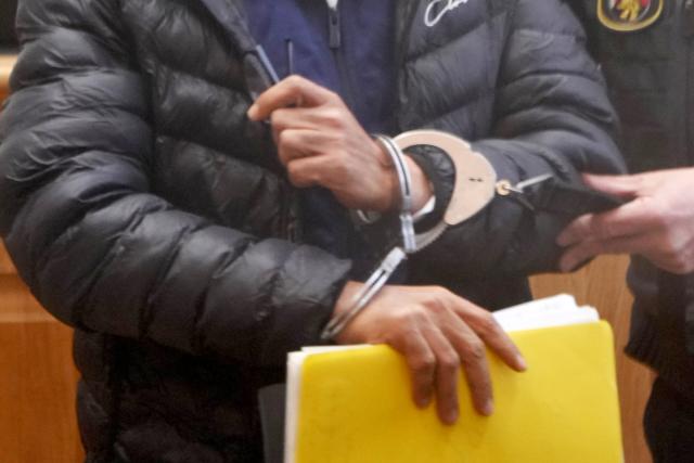 27 April 2026, Rhineland-Palatinate, Koblenz: The defendant enters the Higher Regional Court in Koblenz at the start of his trial for murder and crimes against humanity. The 48-year-old defendant is alleged to have worked as a guard at a Syrian intelligence service prison in Damascus during the Syrian civil war. Photo: Thomas Frey/dpa