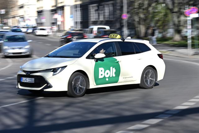 FILED - 09 April 2026, Berlin: A cab with the Bolt logo drives along a road in Berlin. Photo: Michael Brandt/dpa