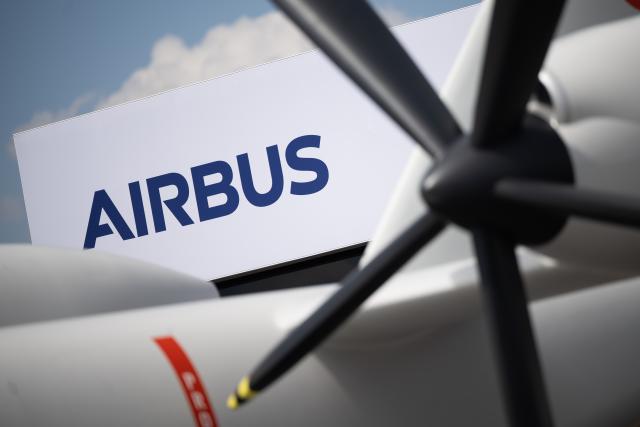 FILED - 06 June 2024, Brandenburg, Schoenefeld: The Airbus logo can be seen behind a model of the Eurodrone during the International Aerospace Exhibition (ILA) at Berlin Brandenburg Airport (BER). Photo: Sebastian Gollnow/dpa