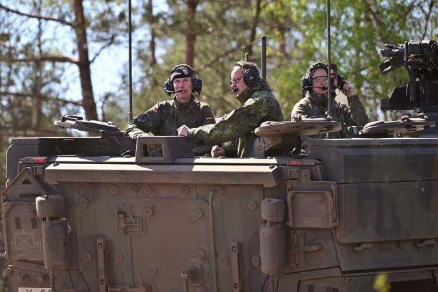 30 April 2026, Lower Saxony, Munster: German Chancellor Friedrich Merz visits the army in Munster and talks to the army inspector, Lieutenant General Christian Freuding (l), in a GTK Boxer wheeled tank. The Federal Chancellor wants to gain an impression of the operational readiness of the land forces and the Army's plans. Photo: Philipp Schulze/dpa