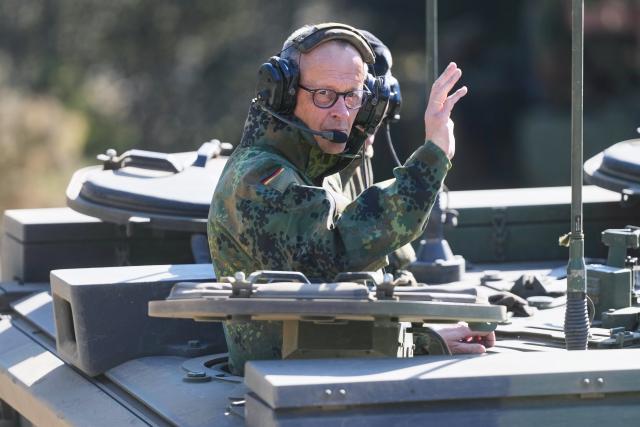 30 April 2026, Lower Saxony, Munster: German Chancellor Friedrich Merz waves from a Boxer armored fighting vehicle during his visit to the Bundeswehr in Munster. Photo: Markus Schreiber/AP POOL/dpa