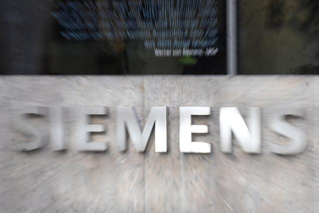 FILED - 18 March 2025, Bavaria, Munich: The "Siemens" logo is seen in front of the conglomerate's headquarters. Photo: Felix Hörhager/dpa