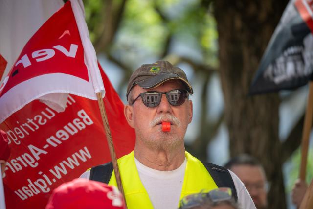 01 May 2026, Rhineland-Palatinate, Trier: A man with a whistle takes part in the central Labor Day event. The occasion is a nationwide trade union rally to mark International Workers' Day. Photo: Harald Tittel/dpa