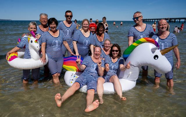 01 May 2026, Mecklenburg-Vorpommern, Binz: Members of the Duesseldorf Cigar Club take a dip in the Baltic Sea to mark the opening of the swimming season at Binz Beach. Photo: Stefan Sauer/dpa