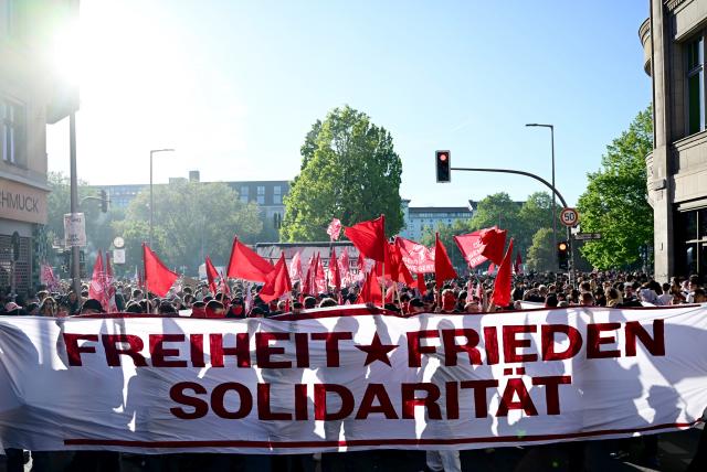 01 May 2026, Berlin: People hold a banner reads "Freedom, Peace, Solidarity" during the "Revolutionary May Day - Freedom. Peace. Solidarity." demonstration. On May 1, several demonstrations and events are taking place across the country. Photo: Sebastian Christoph Gollnow/dpa