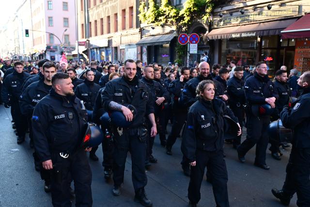 01 May 2026, Berlin: Police officers escort the "Revolutionary May Day - Freedom. Peace. Solidarity." demonstration. On May 1, several demonstrations and events are taking place across the country. Photo: Fabian Sommer/dpa