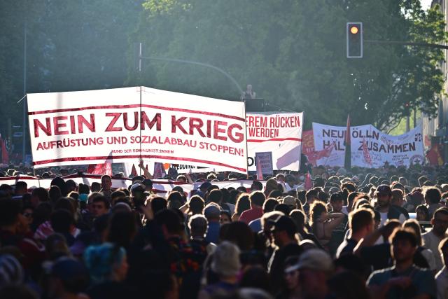 01 May 2026, Berlin: People hold a banner during the "Revolutionary May Day - Freedom. Peace. Solidarity." demonstration. On May 1, several demonstrations and events are taking place across the country. Photo: Sebastian Gollnow/dpa