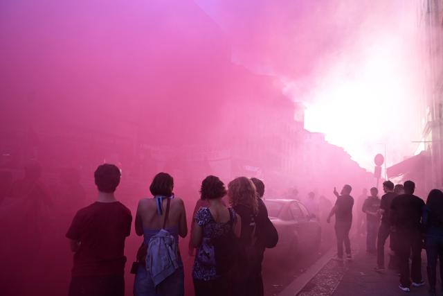 01 May 2026, Berlin: Red smoke drifts through the street during the demonstration titled "Revolutionary May Day - Freedom. Peace. Solidarity". On May 1, several demonstrations and events are taking place across the country. Photo: Fabian Sommer/dpa