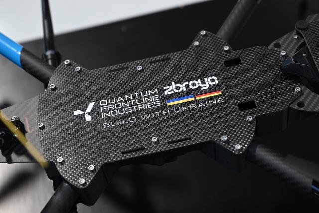 FILED - 13 February 2026, Bavaria, ---: FILE PHOTO - Ukrainian President Volodymyr Zelensky is presented with a drone during a visit to drone manufacturer Quantum Frontline Industries ahead of the Munich Security Conference. Photo: Sven Hoppe/dpa