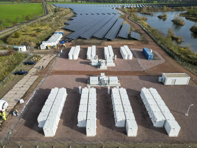 FILED - 12 November 2025, Saxony-Anhalt, Zerbst: FILE PHOTO - There are 88 battery storage units at the new photovoltaic (PV) battery storage hybrid power plant located on the site of a former gravel pit. Photo: Jan Woitas/dpa
